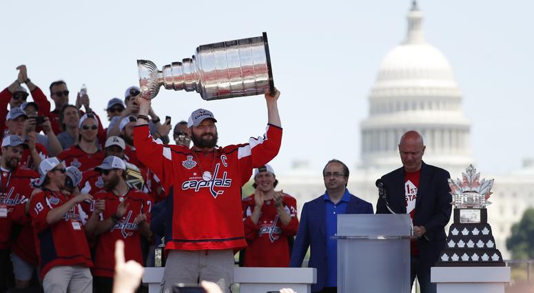 Alex Ovechkin holds up the Stanley Cup at the Washington Capitals' championship parade. Capitals_Stanley_Cup