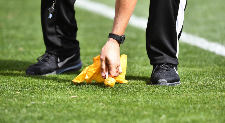 NFL referee throws a flag. nfl_referee