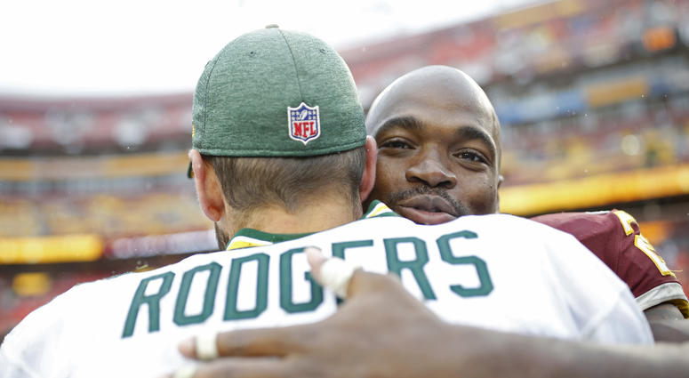 Adrian Peterson and Aaron Rodgers embrace after a game. Adrian_Peterson_Aaron_Rodgers