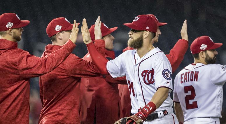 Bryce Harper high fives teammates after a win. Bryce_Harper