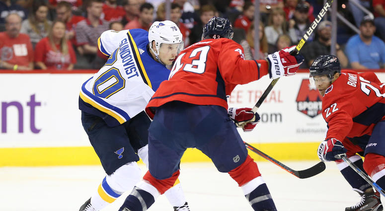 Tom Wilson checks the Blues' Oskar Sundqvist. Tom_Wilson_Check
