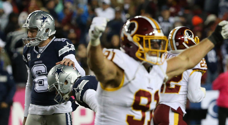 Cowboys kicker Brett Maher is consoled by holder Chris Jones (6) after missing a game-tying field goal attempt on the final play of the fourth quarter, as Redskins linebacker Ryan Kerrigan (91) celebrates. Ryan_Kerrigan_Brett_Maher