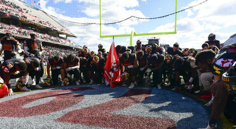 Maryland football players pray before a game. Maryland_Football_Terps