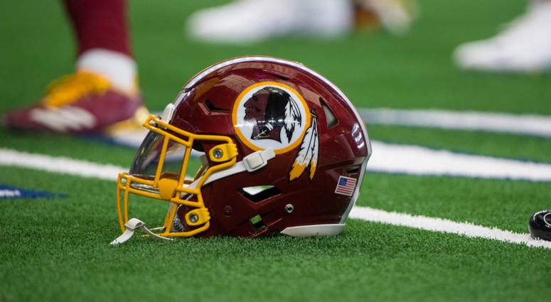 A Redskins helmet sits on the field before a Nov. 2018 game against the Cowboys Source: Redskins hire new executives in business office