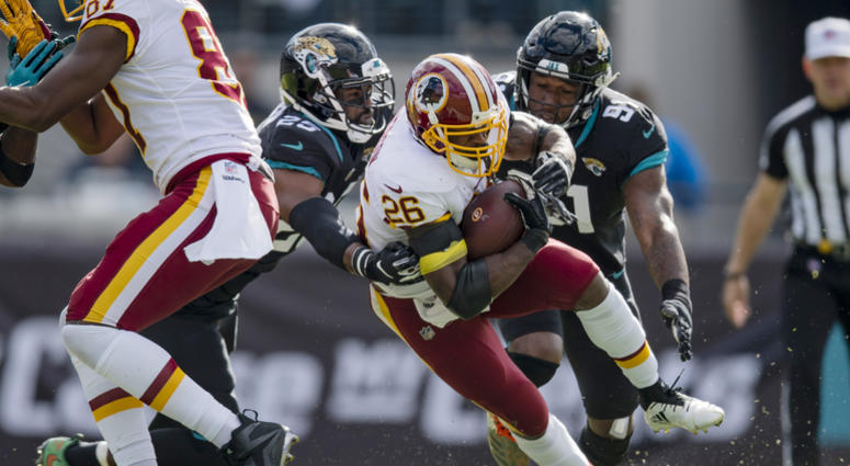 Adrian Peterson carries the ball for the Washington Redskins. Adrian_Peterson_Jaguars