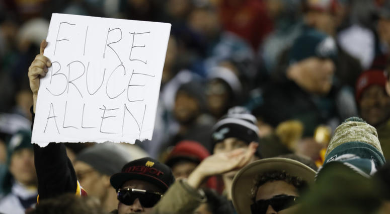 A Redskins fan holds up a "Fire Bruce Allen" sign. Fire_Bruce_Allen_Sign