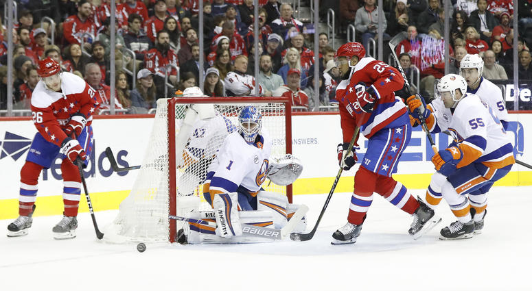 Nic Dowd passes the puck to Devante Smith-Pelly in front of New York Islanders goaltender Thomas Greiss. The Capitals would lose 2-0 to the Islanders. 'No panic' from Capitals despite five-game losing streak