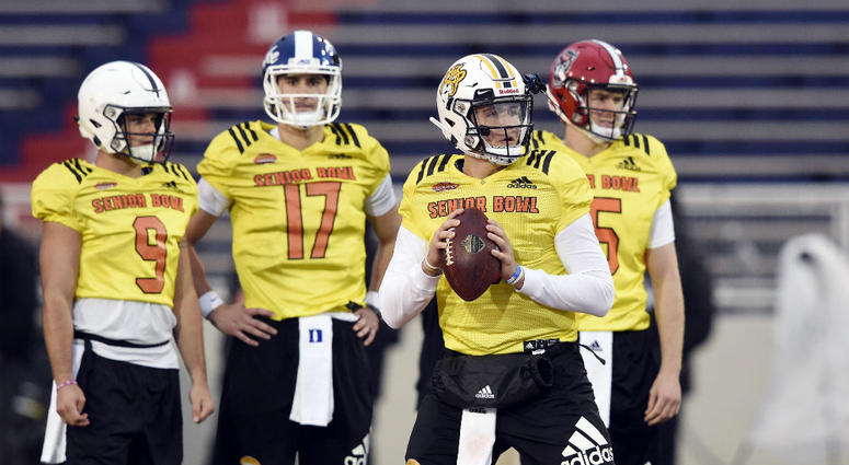 Drew Lock throws a pass as other quarterbacks look on at the Senior Bowl. Latest mock drafts have the Redskins selecting a quarterback in the 1st round.