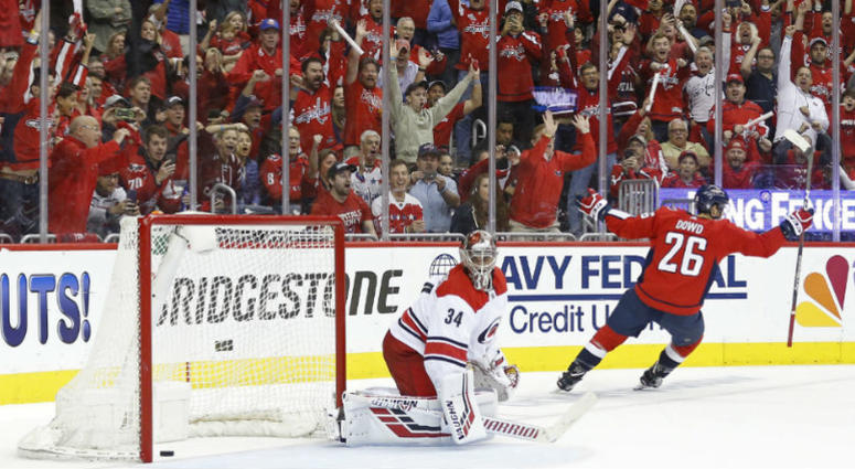 Capitals forward Nic Dowd celebrates his penalty shot goal. Capitals punish Hurricanes are one win away from 2nd round.