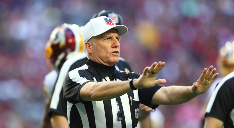 An NFL referee calls a pass interference. NFL_Referees_Redskins