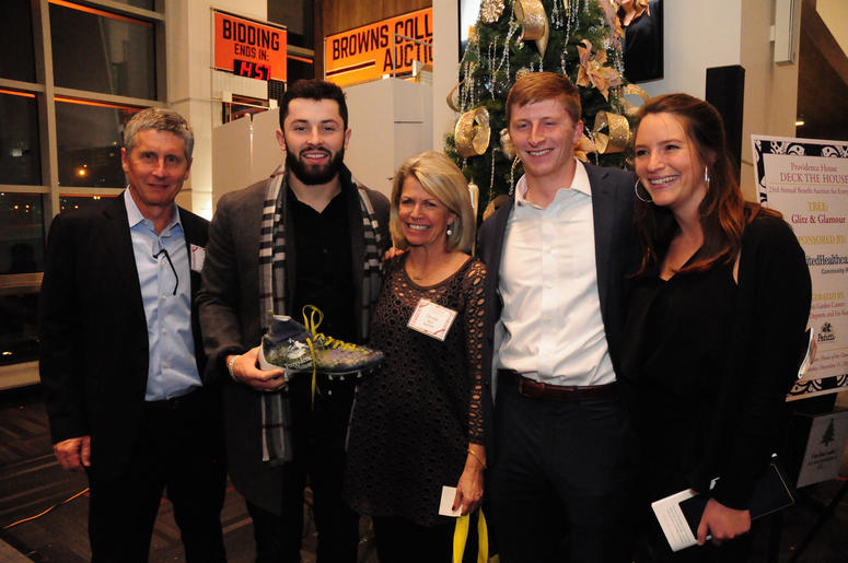 Cleveland Browns rookie quarterback Baker Mayfield poses with the winning bidders of his autographed cleat during the Providence House fundraiser held at FirstEnergy Stadium