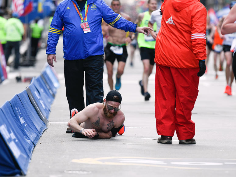 Apr 15, 2019; Boston, MA, USA; Micah Herndon crawls to the finish line of the 2019 Boston Marathon. Mandatory Credit: Brian Fluharty-USA TODAY Sports Apr 15, 2019; Boston, MA, USA; Micah Herndon crawls to the finish line of the 2019 Boston Marathon. Mandatory Credit: Brian Fluharty-USA TODAY Sports