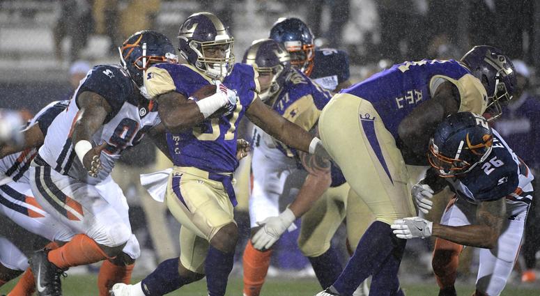 Atlanta Legends running back Lawrence Pittman rushes in front of Orlando Apollos defensive end Anthony Moten Jr. during the second half of an Alliance of American Football game Saturday, Feb. 9, 2019 in Orlando, Florida. Atlanta Legends running back Lawrence Pittman rushes in front of Orlando Apollos defensive end Anthony Moten Jr. during the second half of an Alliance of American Football game Saturday, Feb. 9, 2019 in Orlando, Florida.