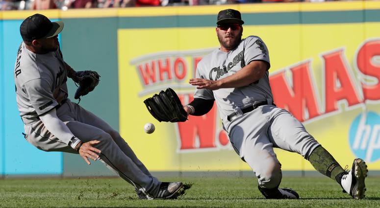 Chicago White Sox's Daniel Palka, right, cannot catch a ball hit by Cleveland Indians' Edwin Encarnacion in the fifth inning of a baseball game, Monday, May 28, 2018, in Cleveland. Yoan Moncada, left, watches. Encanacion was safe at second base for a doub Chicago White Sox's Daniel Palka, right, cannot catch a ball hit by Cleveland Indians' Edwin Encarnacion in the fifth inning of a baseball game, Monday, May 28, 2018, in Cleveland. Yoan Moncada, left, watches. Encanacion was safe at second base for a doub
