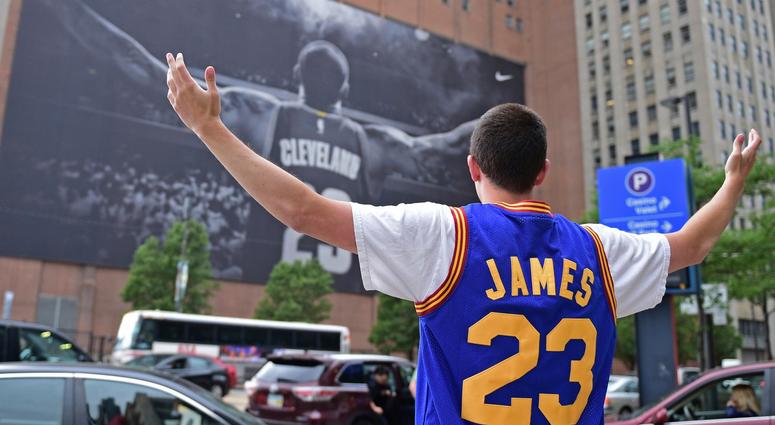 In this June 9, 2017, file photo, Cleveland Cavaliers fan Jordan Phillips poses for a photo in front of a poster featuring Cleveland Cavaliers forward LeBron James, before Game 4 of the basketball's NBA Finals between the Cavaliers and Golden State In this June 9, 2017, file photo, Cleveland Cavaliers fan Jordan Phillips poses for a photo in front of a poster featuring Cleveland Cavaliers forward LeBron James, before Game 4 of the basketball's NBA Finals between the Cavaliers and Golden State