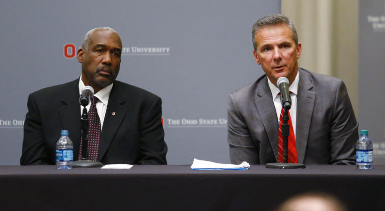 Ohio State suspended Meyer on Wednesday for three games for mishandling domestic violence accusations, punishing one of the sport's most prominent leaders for keeping an assistant on staff for several years after the coach's wife accused him of abuse. At Ohio State football coach Urban Meyer, right, answers questions as athletic director Gene Smith listens during a news conference in Columbus, Ohio, Wednesday, Aug. 22, 2018.