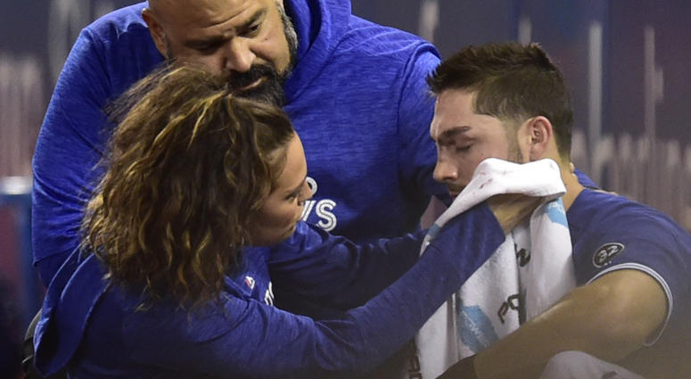 Toronto Blue Jays trainer Nikki Huffman treats Blue Jays right fielder Randal Grichuk (15) after he collided with a security guard in foul territory during fourth inning baseball action against the Cleveland Indians in Toronto, Sunday, Sept. 9, 2018. Toronto Blue Jays trainer Nikki Huffman treats Blue Jays right fielder Randal Grichuk (15) after he collided with a security guard in foul territory during fourth inning baseball action against the Cleveland Indians in Toronto, Sunday, Sept. 9, 2018.