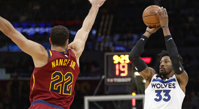 Minnesota Timberwolves' Robert Covington (33) shoots against Cleveland Cavaliers' Larry Nance Jr. (22) in the second half of an NBA basketball game, Monday, Nov. 26, 2018, in Cleveland. Minnesota Timberwolves' Robert Covington (33) shoots against Cleveland Cavaliers' Larry Nance Jr. (22) in the second half of an NBA basketball game, Monday, Nov. 26, 2018, in Cleveland. (AP Photo/Tony Dejak)