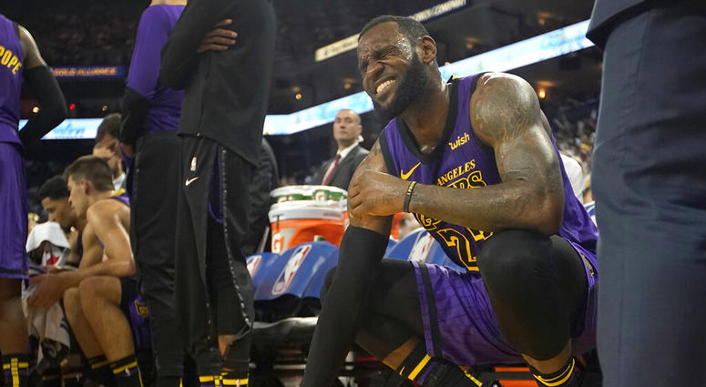 FILE -In this Dec. 25, 2018, file photo, Los Angeles Lakers forward LeBron James (23) reacts after straining his left groin during the second half of an NBA basketball game against the Golden State Warriors in Oakland, Calif. The Lakers say James likely w FILE -In this Dec. 25, 2018, file photo, Los Angeles Lakers forward LeBron James (23) reacts after straining his left groin during the second half of an NBA basketball game against the Golden State Warriors in Oakland, Calif. The Lakers say James likely w