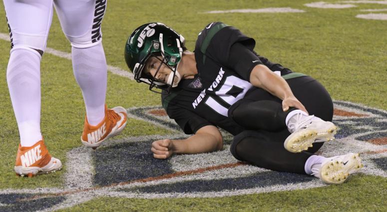 New York Jets quarterback Trevor Siemian (19) grabs his leg after being hurt during the first half of an NFL football game against the Cleveland Browns, Monday, Sept. 16, 2019, in East Rutherford, N.J.