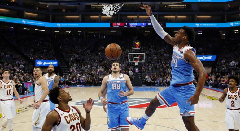 Sacramento Kings guard Buddy Hield dunks over Cleveland Cavaliers guard Brandon Knight (20) during the first quarter of an NBA basketball game Thursday, April 4, 2019, in Sacramento, Calif.