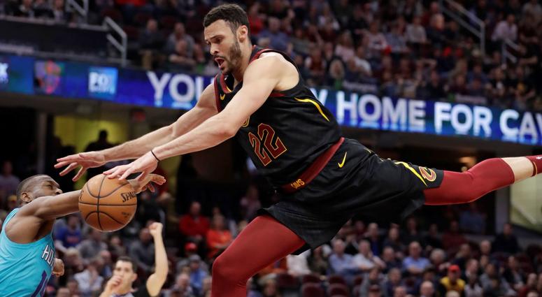 Cleveland Cavaliers' Larry Nance Jr., right, drives to the basket against Charlotte Hornets' Kemba Walker in the first half of an NBA basketball game, Tuesday, April 9, 2019, in Cleveland. Walker was called for a foul.