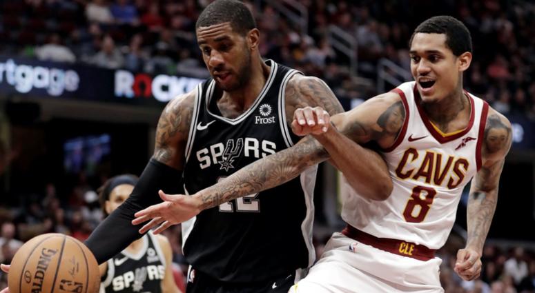 San Antonio Spurs' LaMarcus Aldridge, left, and Cleveland Cavaliers' Jordan Clarkson (8) battle for a rebound in the first half of an NBA basketball game, Sunday, April 7, 2019, in Cleveland.