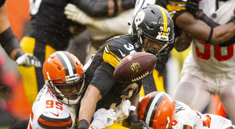 Sep 9, 2018; Cleveland, OH, USA; Cleveland Browns defensive end Myles Garrett (95) and defensive back Derrick Kindred (26) cause a fumble by Pittsburgh Steelers running back James Conner (30) during the fourth quarter at FirstEnergy Stadium.