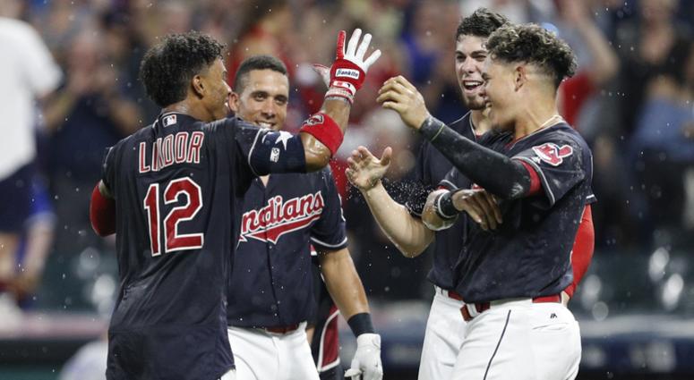 Jul 22, 2017; Cleveland, OH, USA; Cleveland Indians shortstop Francisco Lindor (12) celebrates with left fielder Michael Brantley (23) and center fielder Bradley Zimmer (4) and third baseman Giovanny Urshela (right) after hitting a walk off home run durin Jul 22, 2017; Cleveland, OH, USA; Cleveland Indians shortstop Francisco Lindor (12) celebrates with left fielder Michael Brantley (23) and center fielder Bradley Zimmer (4) and third baseman Giovanny Urshela (right) after hitting a walk off home run durin