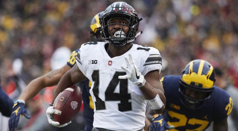 Ohio State Buckeyes wide receiver K.J. Hill (14) runs the ball chased by Michigan Wolverines defensive back David Long (22) in the second half at Michigan Stadium. Ohio State Buckeyes wide receiver K.J. Hill (14) runs the ball chased by Michigan Wolverines defensive back David Long (22) in the second half at Michigan Stadium.
