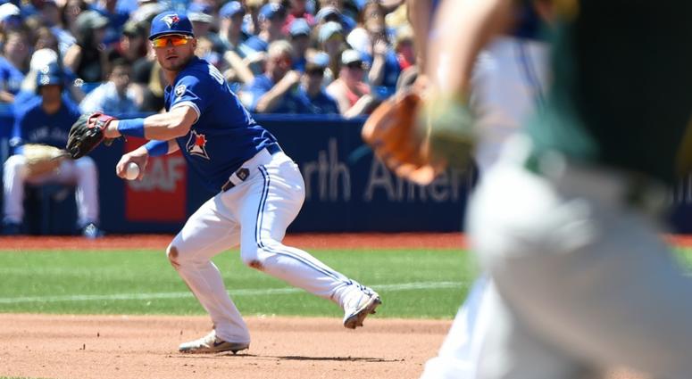 Toronto Blue Jays third baseman Josh Donaldson (20) fields a ball but cannot make the throw on an infield single by Oakland Athletics catcher Jonathan Lucroy (21) in the fifth inning at Rogers Centre. Toronto Blue Jays third baseman Josh Donaldson (20) fields a ball but cannot make the throw on an infield single by Oakland Athletics catcher Jonathan Lucroy (21) in the fifth inning at Rogers Centre.