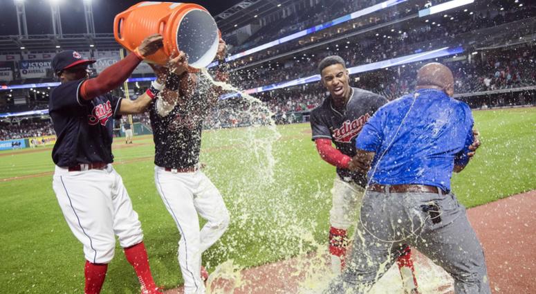 Aug 8, 2018; Cleveland, OH, USA; Cleveland Indians center fielder Rajai Davis (26) and catcher Yan Gomes (7) douse shortstop Francisco Lindor (12) and television personality Andre Knott with Gatorade after Lindor ended the game with a three-run home run a Aug 8, 2018; Cleveland, OH, USA; Cleveland Indians center fielder Rajai Davis (26) and catcher Yan Gomes (7) douse shortstop Francisco Lindor (12) and television personality Andre Knott with Gatorade after Lindor ended the game with a three-run home run a