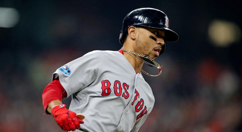 Boston Red Sox right fielder Mookie Betts (50) runs to first base after singling in the first inning against the Houston Astros in game three of the 2018 ALCS playoff baseball series at Minute Maid Park. Mandatory Credit: Troy Taormina-USA TODAY Sports
