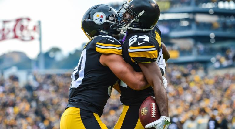 Pittsburgh Steelers wide receiver Antonio Brown (84) reacts with running back James Conner (30) after Brown scored a touchdown during the second quarter against the Cleveland Browns at Heinz Field. Pittsburgh Steelers wide receiver Antonio Brown and running back James Conner