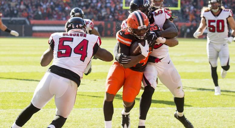 Cleveland Browns running back Nick Chubb (24) scores a touchdown between the defense of Atlanta Falcons linebacker Foye Oluokun (54) and outside linebacker De'Vondre Campbell (59) during the second quarter at FirstEnergy Stadium