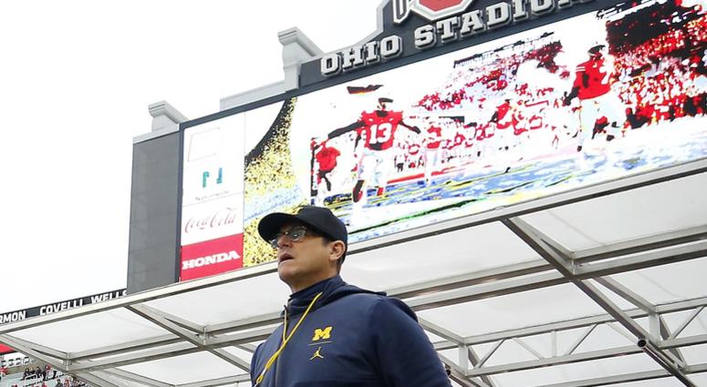 Michigan Wolverines head coach Jim Harbaugh walks on to the field before a game against the Ohio State Buckeyes at Ohio Stadium. Jim Harbaugh