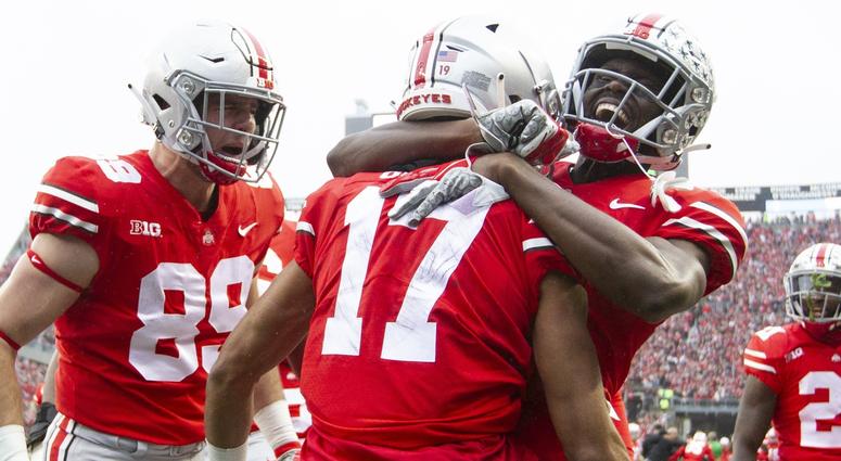 Ohio State Buckeyes wide receiver Chris Olave (17) is congratulated by tight end Luke Farrell (89) and wide receiver Binjimen Victor (9) after scoring a touchdown against the Michigan Wolverines at Ohio Stadium. Ohio State Buckeyes wide receiver Chris Olave (17) is congratulated by tight end Luke Farrell (89) and wide receiver Binjimen Victor (9) after scoring a touchdown against the Michigan Wolverines at Ohio Stadium.