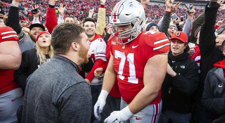 Ohio State Buckeyes offensive lineman Josh Myers (71) celebrates with fans after defeating the Michigan Wolverines at Ohio Stadium.