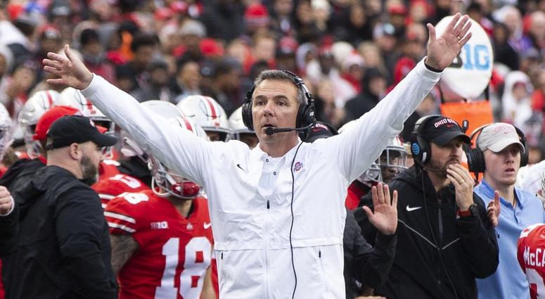 Ohio State Buckeyes head coach Urban Meyer tries to get the attention of the referee against the Michigan Wolverines at Ohio Stadium. Urban Meyer