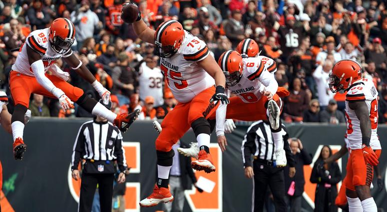 Browns offensive guard Joel Bitonio (75) spikes the ball to celebrate the touchdown by tight end David Njoku (85) against the Cincinnati Bengals.