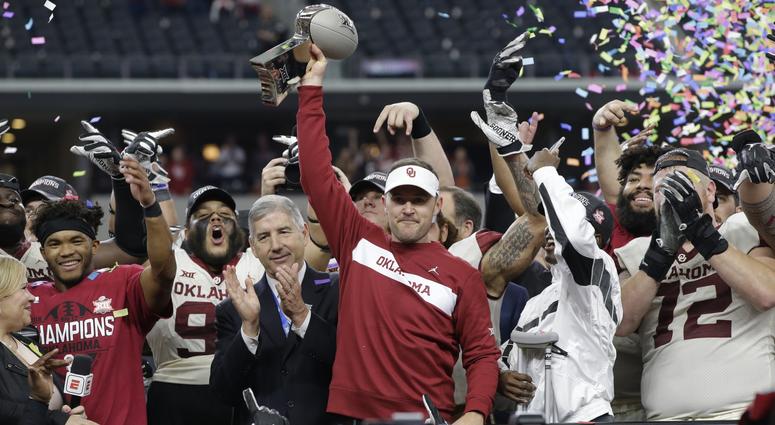Oklahoma Sooners head coach Lincoln Riley holds up the championship trophy after the game against the Texas Longhorns in the Big 12 championship game at AT&T Stadium.