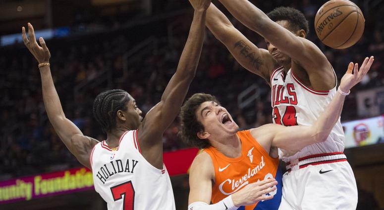 Dec 23, 2018; Cleveland, OH, USA; Cleveland Cavaliers forward Cedi Osman (16) drives to the basket between Chicago Bulls forward Justin Holiday (7) and forward Wendell Carter Jr. (34) at Quicken Loans Arena. Mandatory Credit: Ken Blaze-USA TODAY Sports Dec 23, 2018; Cleveland, OH, USA; Cleveland Cavaliers forward Cedi Osman (16) drives to the basket between Chicago Bulls forward Justin Holiday (7) and forward Wendell Carter Jr. (34) at Quicken Loans Arena. Mandatory Credit: Ken Blaze-USA TODAY Sports