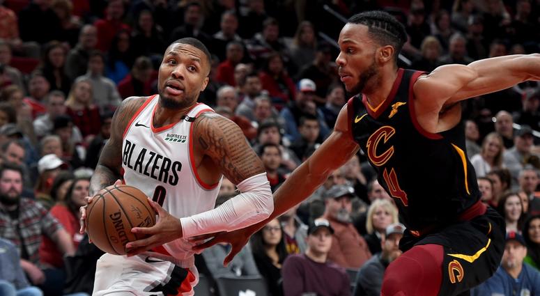 Jan 16, 2019; Portland, OR, USA; Portland Trail Blazers guard Damian Lillard (0) dribbles the ball past Cleveland Cavaliers forward Jaron Blossomgame (4) during the first half at the Moda Center. Mandatory Credit: Steve Dykes-USA TODAY Sports Jan 16, 2019; Portland, OR, USA; Portland Trail Blazers guard Damian Lillard (0) dribbles the ball past Cleveland Cavaliers forward Jaron Blossomgame (4) during the first half at the Moda Center. Mandatory Credit: Steve Dykes-USA TODAY Sports
