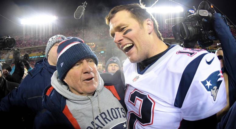 New England Patriots head coach Bill Belichick and quarterback Tom Brady (12) celebrate the win over the Kansas City Chiefs during overtime in the AFC Championship game at Arrowhead Stadium.
