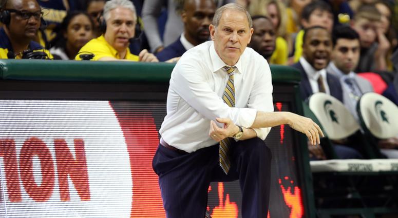 Michigan Wolverines head coach John Beilein knees on the court during the second half of a game against the Michigan State Spartans at the Breslin Center. Michigan Wolverines head coach John Beilein knees on the court during the second half of a game against the Michigan State Spartans at the Breslin Center.