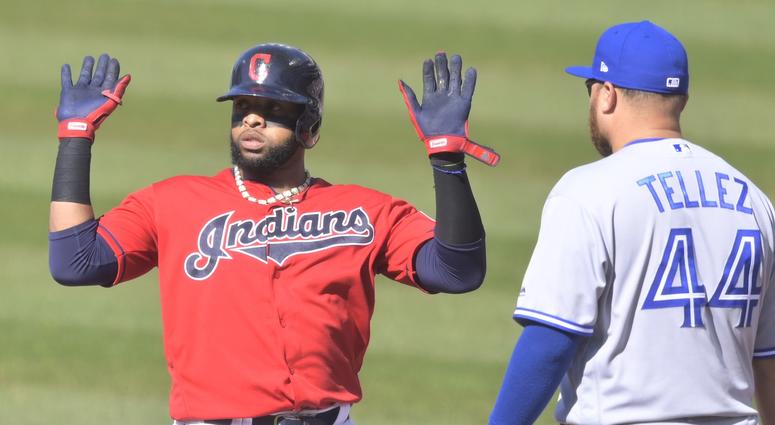 Cleveland Indians first baseman Carlos Santana (41) celebrates after hitting an RBI single in the first inning beside Toronto Blue Jays first baseman Rowdy Tellez (44) at Progressive Field. Cleveland Indians first baseman Carlos Santana (41) celebrates after hitting an RBI single in the first inning beside Toronto Blue Jays first baseman Rowdy Tellez (44) at Progressive Field.