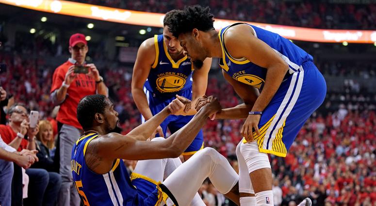 Golden State Warriors forward Kevin Durant (35) is helped up by guard Quinn Cook (4) and guard Klay Thompson (11) after an apparent injury during the second quarter in game five of the 2019 NBA Finals against the Toronto Raptors at Scotiabank Arena. Golden State Warriors forward Kevin Durant (35) is helped up by guard Quinn Cook (4) and guard Klay Thompson (11) after an apparent injury during the second quarter in game five of the 2019 NBA Finals against the Toronto Raptors at Scotiabank Arena.