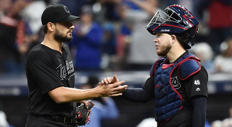 Aug 23, 2019; Cleveland, OH, USA; Cleveland Indians relief pitcher Brad Hand (33) and catcher Roberto Perez (55) celebrate after the Indians beat the Kansas City Royals during an MLB Players' Weekend game at Progressive Field. Cleveland Indians pitcher Brad Hand (left) and catcher Roberto Perez (right)