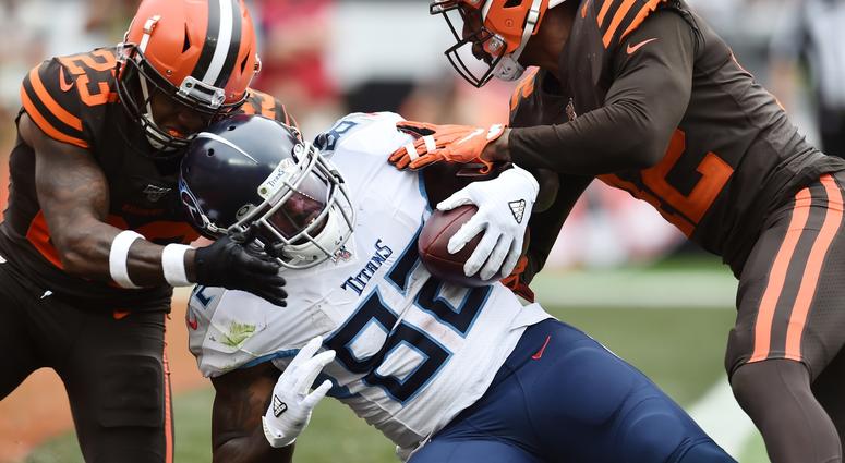 Sep 8, 2019; Cleveland, OH, USA; Tennessee Titans tight end Delanie Walker (82) scores a touchdown as Cleveland Browns strong safety Damarious Randall (23) and strong safety Morgan Burnett (42) defend during the second half at FirstEnergy Stadium. Tennessee Titans tight end Delanie Walker (82) scores a touchdown as Cleveland Browns strong safety Damarious Randall (23) and strong safety Morgan Burnett (42) defend