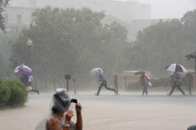 Tourist walk through heavy rain on the grounds of the US Capitol building, on July 28, 2017 in Washington, DC. Heavy rain was forcast for today and flash flood warnings were issued for certain areas. Tourist walk through heavy rain on the grounds of the US Capitol building, on July 28, 2017 in Washington, DC. Heavy rain was forcast for today and flash flood warnings were issued for certain areas.